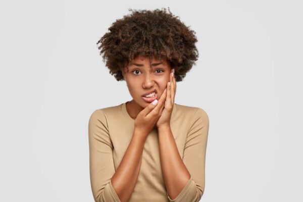 Patient experiencing tooth sensitivity to cold food and drinks